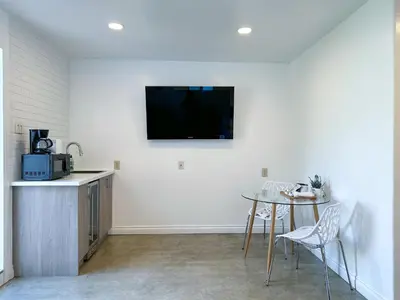 a kitchen with a table and a tv on a wall at Monthier Picfair Village CA1G6H23 in Los Angeles