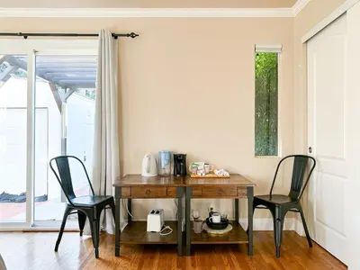 a table and chairs in a room with a window at Monthier Picfair Village CA1G6R23 in Los Angeles