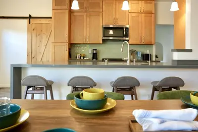 a kitchen with wooden cabinets and a wooden table with bowls on it at Monthier The Grove OA7T4H55 in Los Angeles