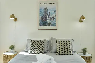 a bedroom with a bed with a poster on the wall at Monthier The Grove OA7T4H55 in Los Angeles