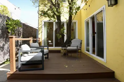 a wooden deck with chairs and a tree on it at Monthier The Grove OA7T4H55 in Los Angeles