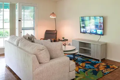 a living room with a couch and a tv at Los Angeles Townhouse close to LACMA in Los Angeles