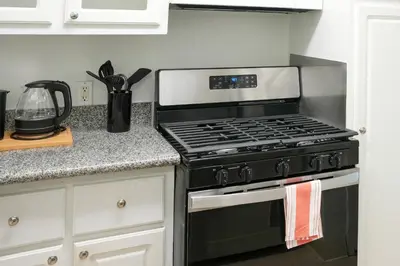 a kitchen with a black stove top oven at Los Angeles Townhouse close to LACMA in Los Angeles