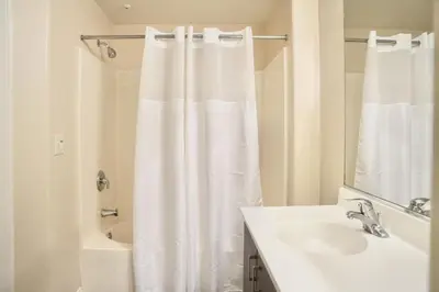 a bathroom with a shower curtain and a sink at Los Angeles Suite LACMA in Los Angeles