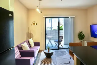 a living room with a couch and a tv at Los Angeles Suite LACMA in Los Angeles