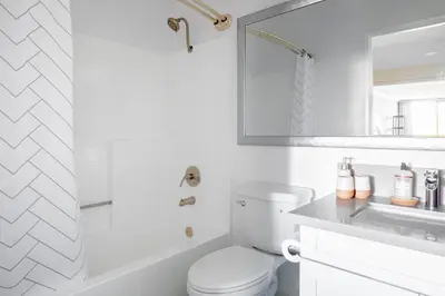 a white bathroom with a toilet and a sink at Brentwood Studio w Pool nr UCLA Whole Foods LAX-290 in Los Angeles