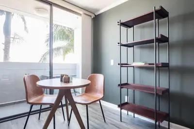 a dining room with a table and chairs and a shelf at Brentwood Studio w Pool nr UCLA Whole Foods LAX-290 in Los Angeles
