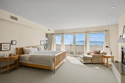 a bedroom with a bed and a couch and a fireplace at Sand Side Bliss in Oxnard
