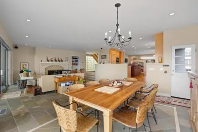 a dining room and living room with a table and chairs at Sand Side Bliss in Oxnard