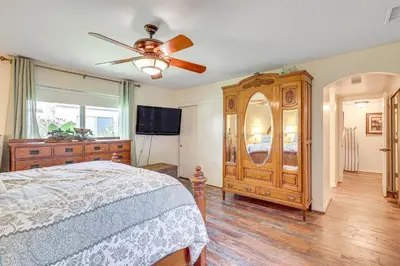 a bedroom with a large wooden dresser and a bed at Redlands Home with Community Perks 1 Mi to Downtown in Redlands