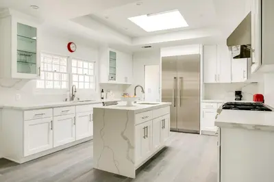 a white kitchen with white cabinets and a sink at Monthier Melrose PO7H2O0 in Los Angeles