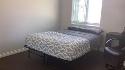 a small bed in a room with a window at House Downtown OC Santa Ana in Santa Ana