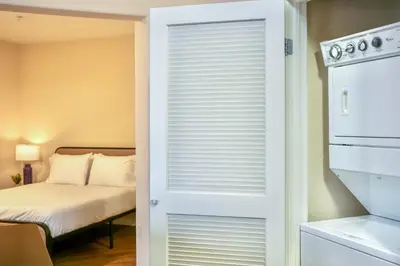a door leading into a bedroom with a bed at Los Angeles Modern Studio in Los Angeles