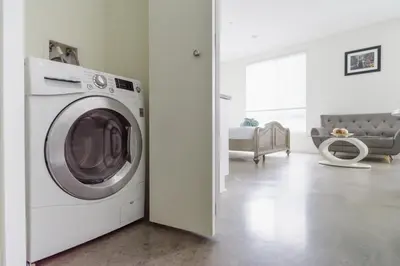 a white washing machine in a living room at Suite Little Tokyo Los Angeles in Los Angeles