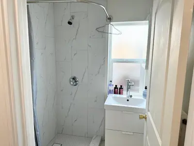 a bathroom with a shower and a sink at Brand-New Dtla building with rooftop patio in Alhambra