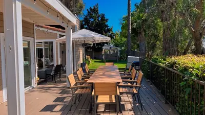 a wooden table and chairs on a deck at Panorama Tropical Resort & Spa with Sunset City View in Santa Ana