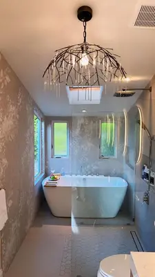a bathroom with a tub and a sink and a chandelier at Panorama Tropical Resort & Spa with Sunset City View in Santa Ana