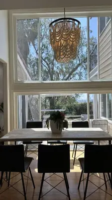 a dining room table with chairs and a large window at Panorama Tropical Resort & Spa with Sunset City View in Santa Ana