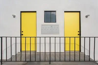 two yellow doors on a building with a window at Sunny 1 Bedroom in the Heart of Venice Beach - 2 in Los Angeles