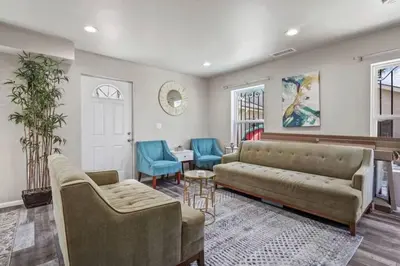 a living room with a couch and two chairs at Spacious family Guesthouse private entry near six flags in Santa Clarita