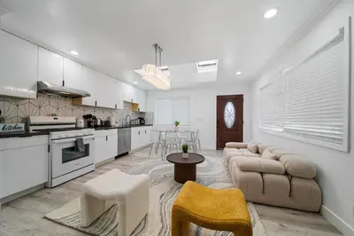 a kitchen and living room with a couch and a table at # Marbella Lane - Serene and Pristine 2BR Home in West Covina
