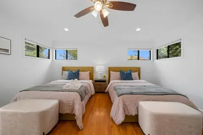a bedroom with two beds and a ceiling fan at # Marbella Lane - Serene and Pristine 2BR Home in West Covina