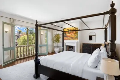a bedroom with a large bed and a balcony at The Canal Escape - canal-front Italian villa in Los Angeles