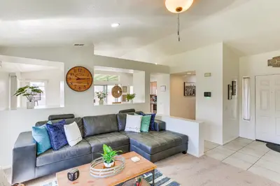 a living room with a couch and a table at Victorville Home with Large Yard and Charcoal Grill! in Victorville