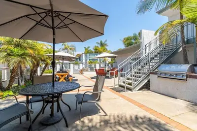 a table with an umbrella on a patio at Carpinteria Beach Studio Condo in Carpinteria
