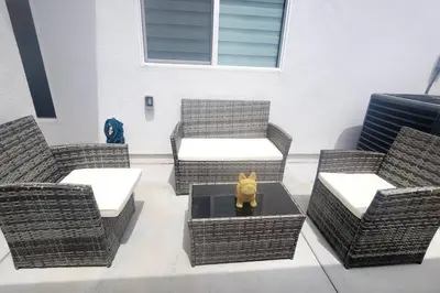 a cat figurine sitting on a table with wicker chairs at H&H New Built 2023 Hidden Gem Heart of OC 3 Queen Beds in Westminster