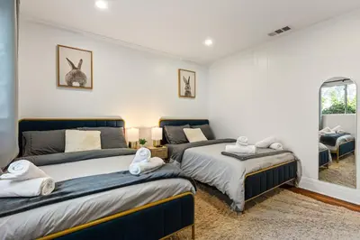 a bedroom with two beds and a window at Los Angeles charming big house, king bed, parking, EV in Los Angeles