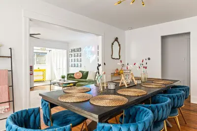 a dining room with a table and blue chairs at Los Angeles charming big house, king bed, parking, EV in Los Angeles