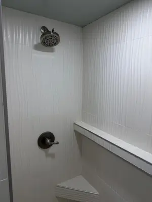 a bathroom with a shower with a toilet and a light at Pasadena Old Town village in Pasadena