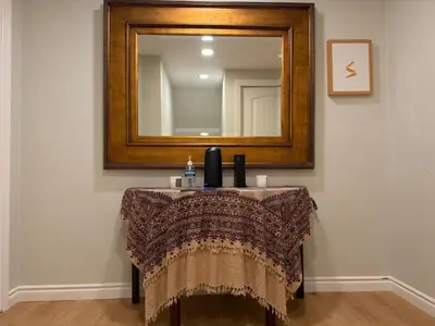 a table in a room with a mirror and a dressing table at Pasadena Old Town village in Pasadena