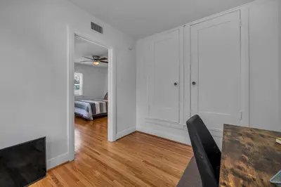 an empty living room with a table and a bedroom at Chic Charming 2-Bedroom with office in the WeHo in Los Angeles