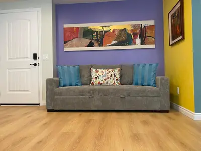 a couch in a living room with a purple wall at Pasadena Old Town in Pasadena
