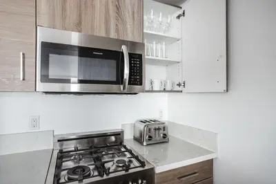 a kitchen with a microwave and a stove top oven at Blueground Hollywood gym near Walk of Fame LAX-1217 in Los Angeles