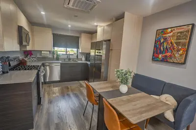 a kitchen with a table and a dining room at Corner Haus Los Angeles in Los Angeles