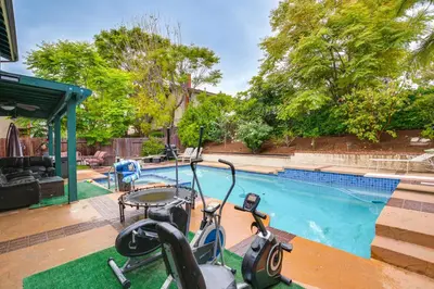 a swimming pool with two exercise bikes parked next to it at Anaheim Home with Pool, 14 Mi to Disneyland! in Anaheim
