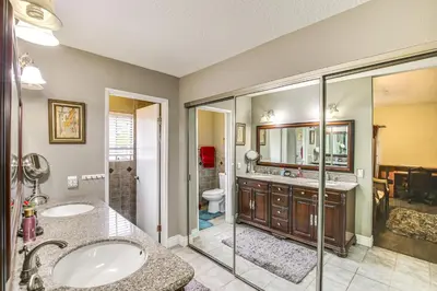 a bathroom with two sinks and a shower at Anaheim Home with Pool, 14 Mi to Disneyland! in Anaheim