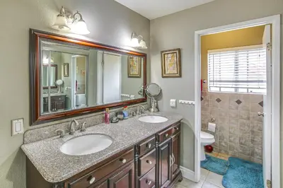 a bathroom with two sinks and a shower at Anaheim Home with Pool, 14 Mi to Disneyland! in Anaheim