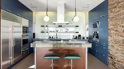 a kitchen with blue cabinets and stainless steel appliances at Hollywood Overlook by AvantStay Private Pool Hot Tub Panoramic Views in Los Angeles