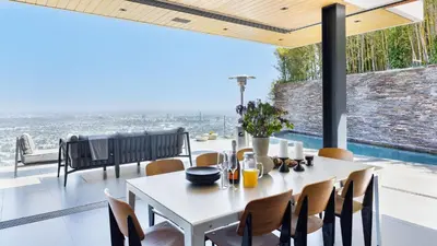 a dining room with a table and chairs at Hollywood Overlook by AvantStay Private Pool Hot Tub Panoramic Views in Los Angeles