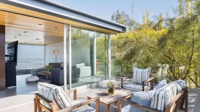 a glass house with a view of the city at Hollywood Overlook by AvantStay Private Pool Hot Tub Panoramic Views in Los Angeles