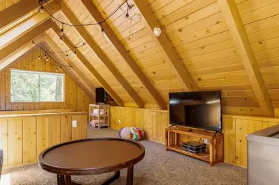a living room with a tv and a table at Family Lake Arrowhead Home Sleeps 12 and Gameroom in Lake Arrowhead