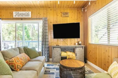 a living room with a couch and a flat screen tv at Family Lake Arrowhead Home Sleeps 12 and Gameroom in Lake Arrowhead