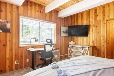 a bedroom with a bed and a desk and a window at Family Lake Arrowhead Home Sleeps 12 and Gameroom in Lake Arrowhead