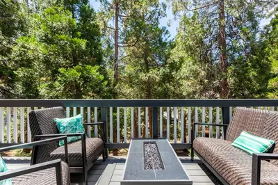 a patio with two chairs and a table on a deck at Family Lake Arrowhead Home Sleeps 12 and Gameroom in Lake Arrowhead