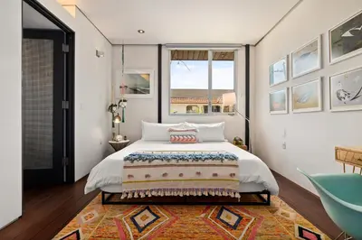 a bedroom with a large bed and a window at Venice Rooftop 5bd 4 bt steps from the beach in Los Angeles