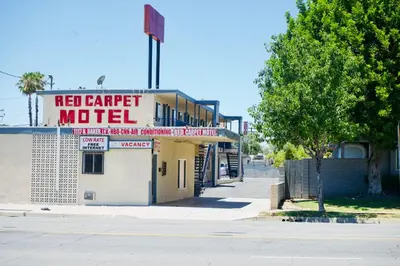a building with a sign for a red carpet motel at Red Carpet Motel By Ontario in Ontario